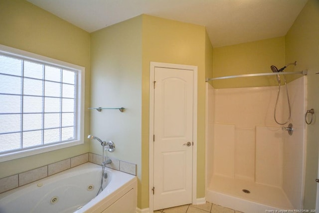 full bath featuring a whirlpool tub, tile patterned flooring, and walk in shower