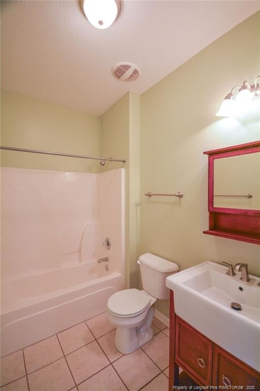 bathroom featuring toilet, visible vents, bathing tub / shower combination, vanity, and tile patterned floors