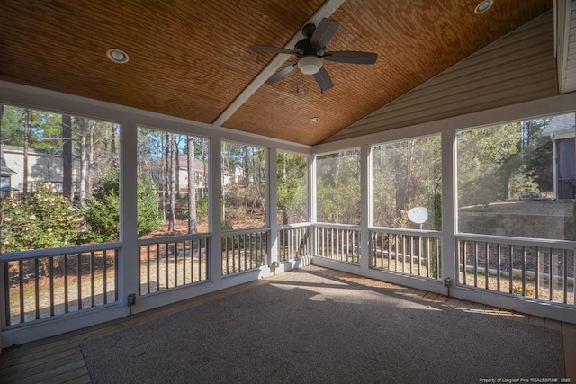 unfurnished sunroom with lofted ceiling, wooden ceiling, and ceiling fan