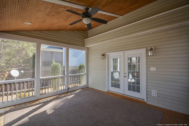 unfurnished sunroom featuring lofted ceiling, french doors, wooden ceiling, and ceiling fan