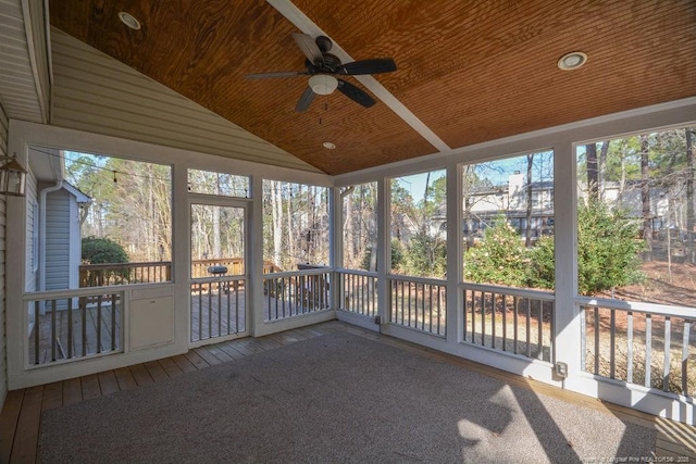 unfurnished sunroom featuring plenty of natural light, ceiling fan, wooden ceiling, and lofted ceiling