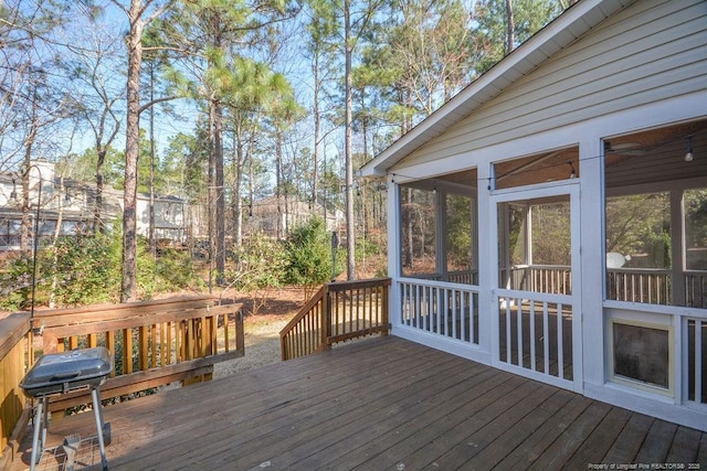 deck featuring a sunroom and area for grilling