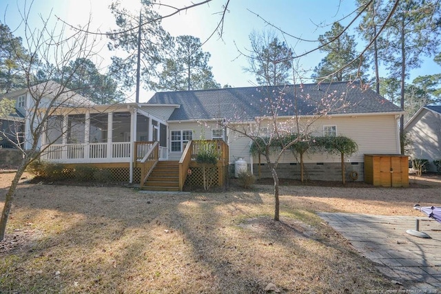 view of front of house featuring a deck, a shingled roof, a sunroom, stairs, and crawl space