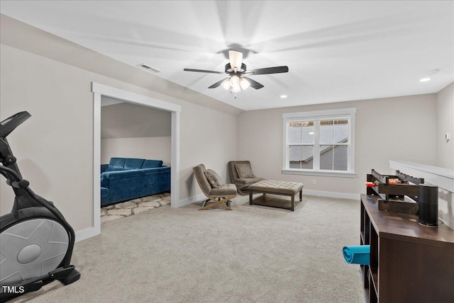 living area with baseboards, visible vents, ceiling fan, and carpet flooring