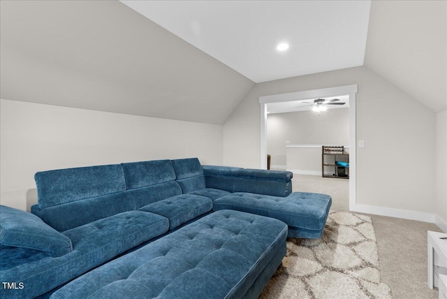 carpeted living area featuring lofted ceiling and baseboards