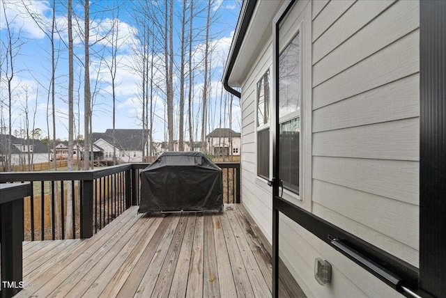 wooden terrace with a grill