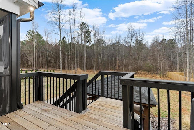 wooden terrace featuring a view of trees