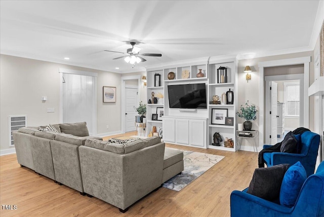 living room with light wood-type flooring, ceiling fan, ornamental molding, and baseboards