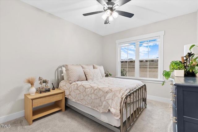 bedroom featuring baseboards, a ceiling fan, and light colored carpet