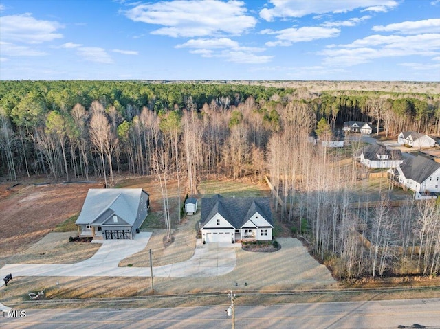 drone / aerial view with a wooded view