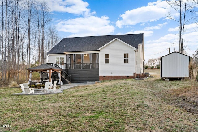 rear view of house with a patio, a sunroom, crawl space, a gazebo, and a yard