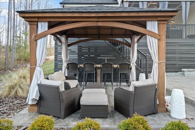 view of patio with an outdoor living space, outdoor dry bar, and a gazebo