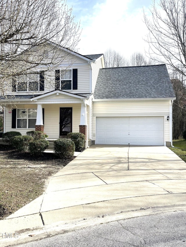 traditional-style house featuring covered porch, concrete driveway, a shingled roof, and an attached garage