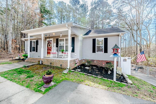 bungalow-style house with covered porch and fence