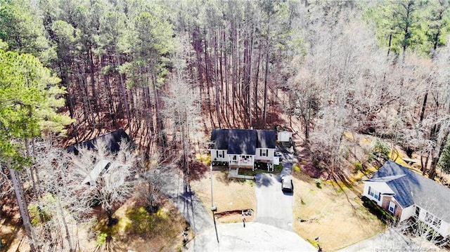 bird's eye view featuring a wooded view