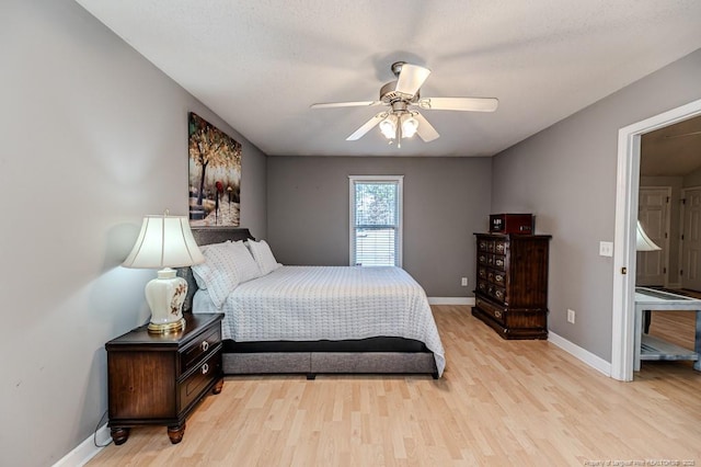 bedroom featuring ceiling fan, light wood-type flooring, and baseboards