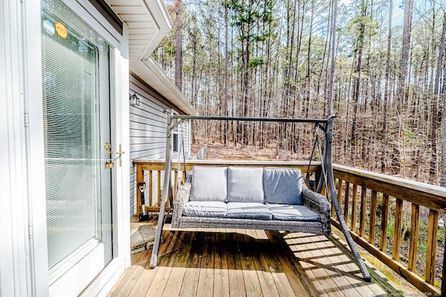 wooden deck with an outdoor living space