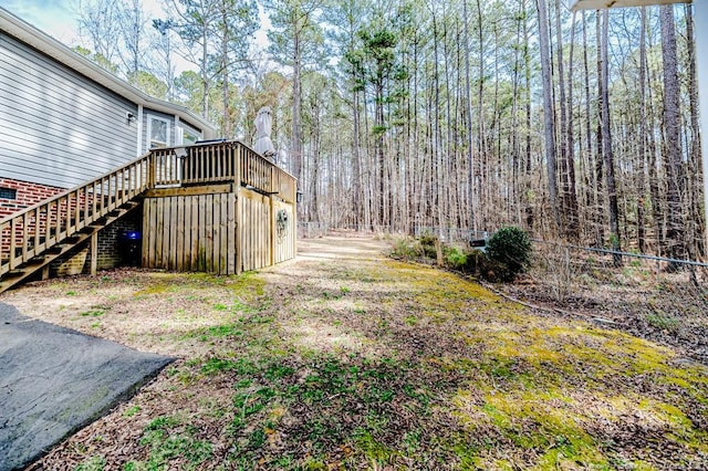 view of yard featuring a wooden deck and stairs