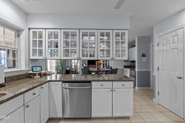 kitchen featuring glass insert cabinets, dark stone counters, white cabinets, and a peninsula