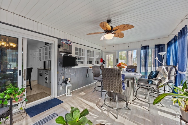 sunroom / solarium with a ceiling fan