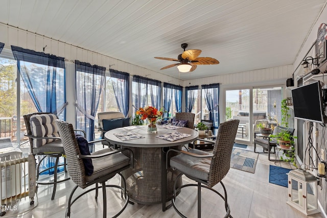 sunroom / solarium featuring ceiling fan