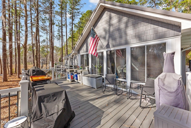 wooden deck with a sunroom