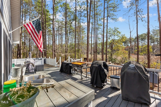 deck with a grill and a sink