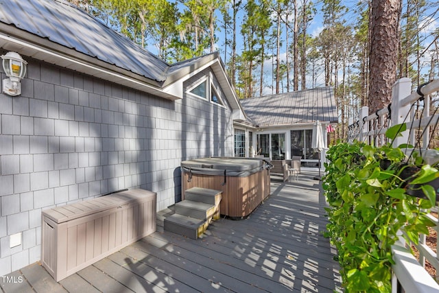 wooden deck with a hot tub