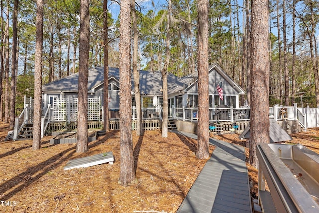 rear view of house featuring a deck