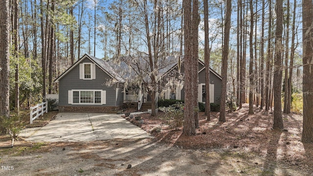 rustic home with fence and a porch