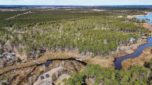 birds eye view of property with a water view and a view of trees