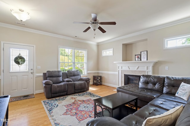 801 Myrtle Grove Ln, Apex, NC 27502 - living room with visible vents, ceiling fan, crown molding, light wood finished floors, and a glass covered fireplace