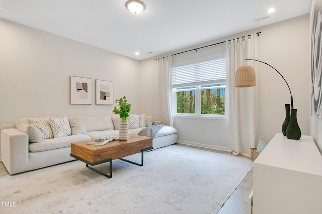 living area featuring visible vents, recessed lighting, light wood-style floors, and baseboards