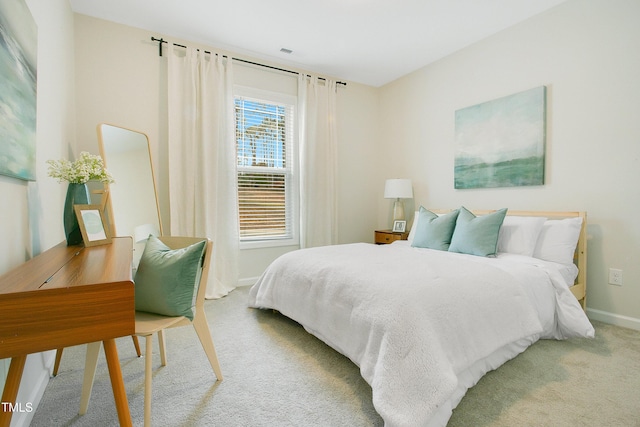 bedroom featuring baseboards and carpet flooring