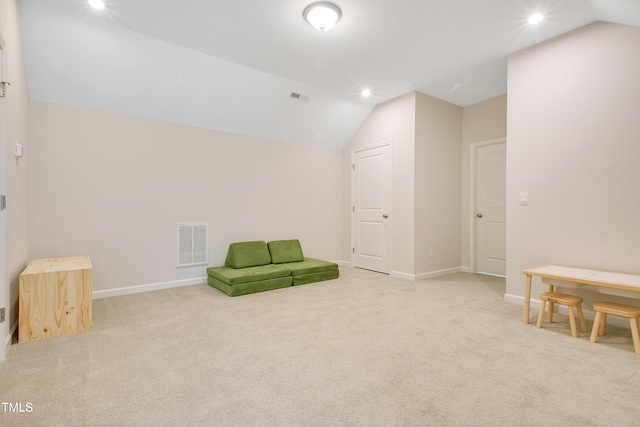 unfurnished room featuring vaulted ceiling, carpet flooring, and visible vents