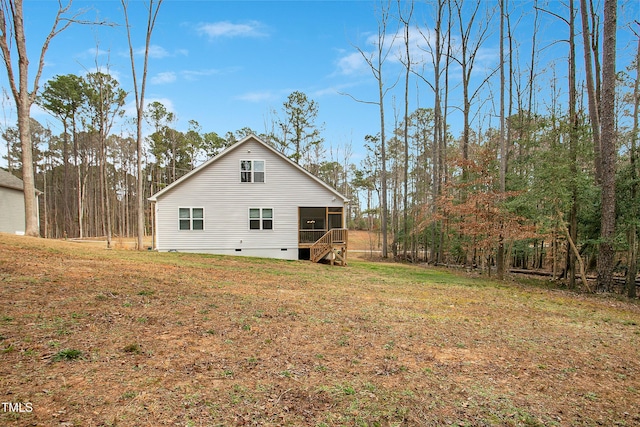 back of property featuring crawl space, a yard, and a sunroom