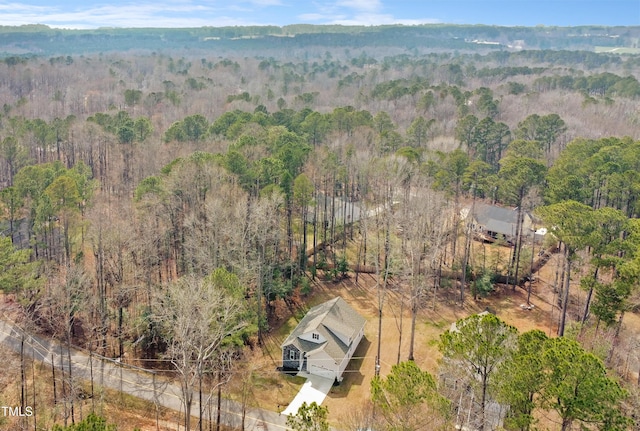 birds eye view of property featuring a view of trees