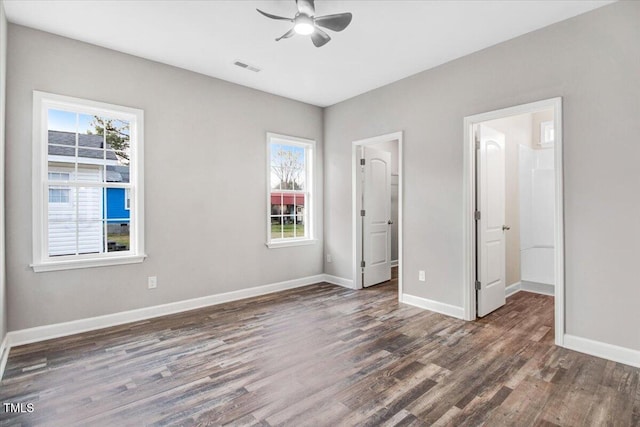 unfurnished bedroom featuring visible vents, baseboards, and wood finished floors