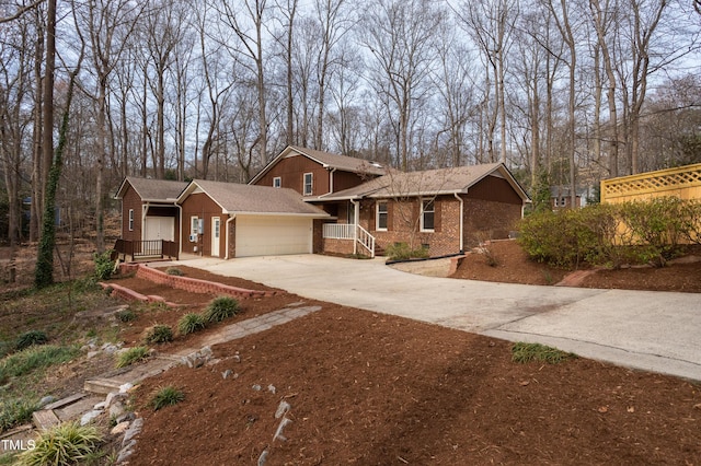 view of front facade with an attached garage, brick siding, and driveway