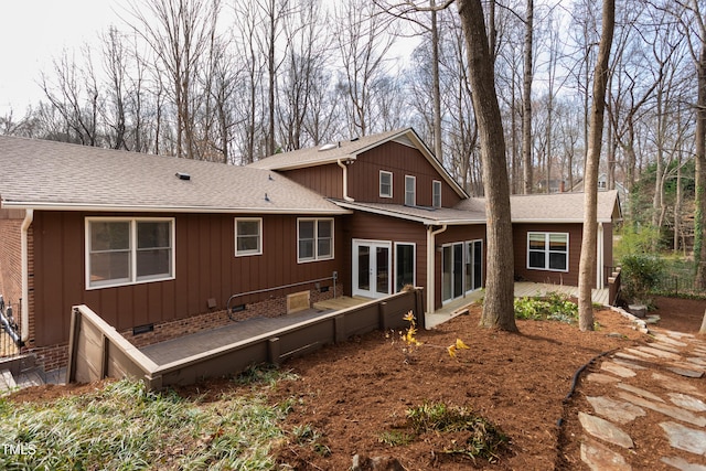 rear view of house featuring a patio area, french doors, board and batten siding, and a shingled roof