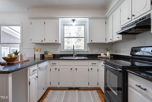 kitchen featuring a peninsula, a sink, black electric range, under cabinet range hood, and dishwasher