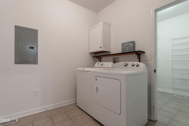 washroom with independent washer and dryer, electric panel, cabinet space, light tile patterned floors, and baseboards