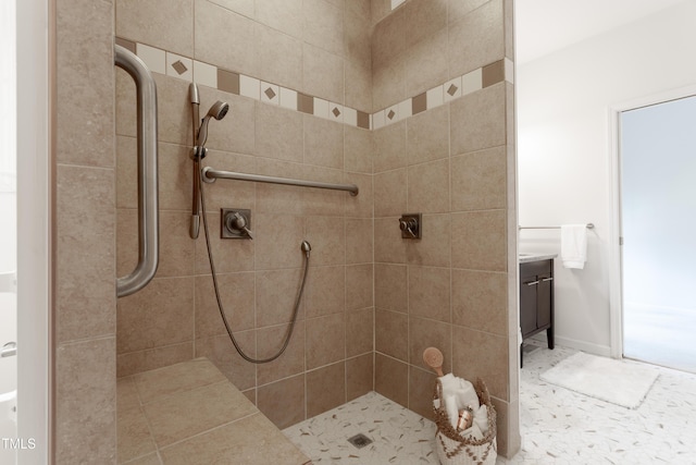 bathroom with baseboards and tiled shower