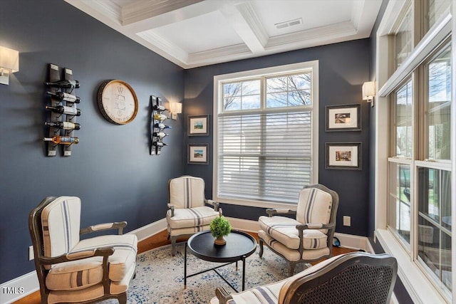 living area featuring beamed ceiling, coffered ceiling, baseboards, and ornamental molding