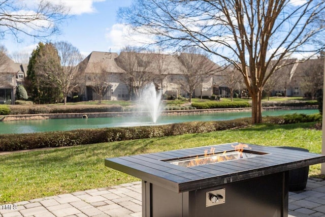 view of patio featuring an outdoor fire pit and a water view