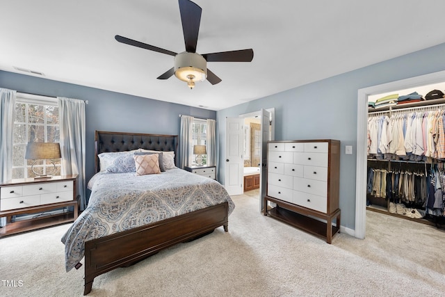 carpeted bedroom featuring visible vents, a ceiling fan, a closet, baseboards, and a spacious closet