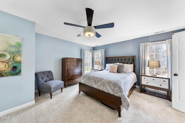 bedroom with a ceiling fan, baseboards, visible vents, and carpet floors