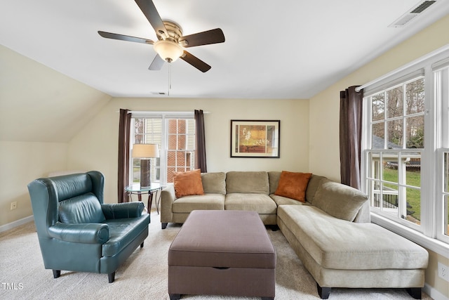 living room featuring visible vents, lofted ceiling, baseboards, and ceiling fan