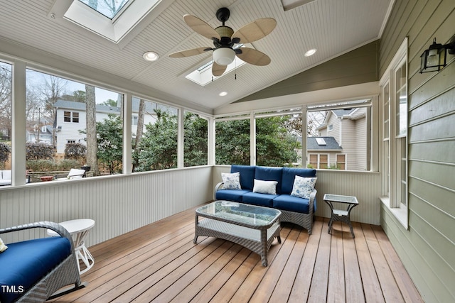 sunroom with vaulted ceiling with skylight and a ceiling fan