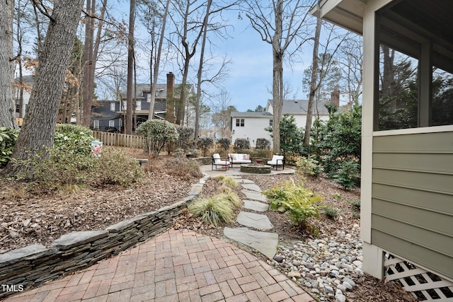 view of yard with a patio area, an outdoor fire pit, and fence